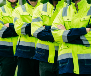 A lineup of people wearing hi-vis jackets.