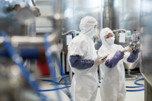 Pharma workers wearing PPE suits