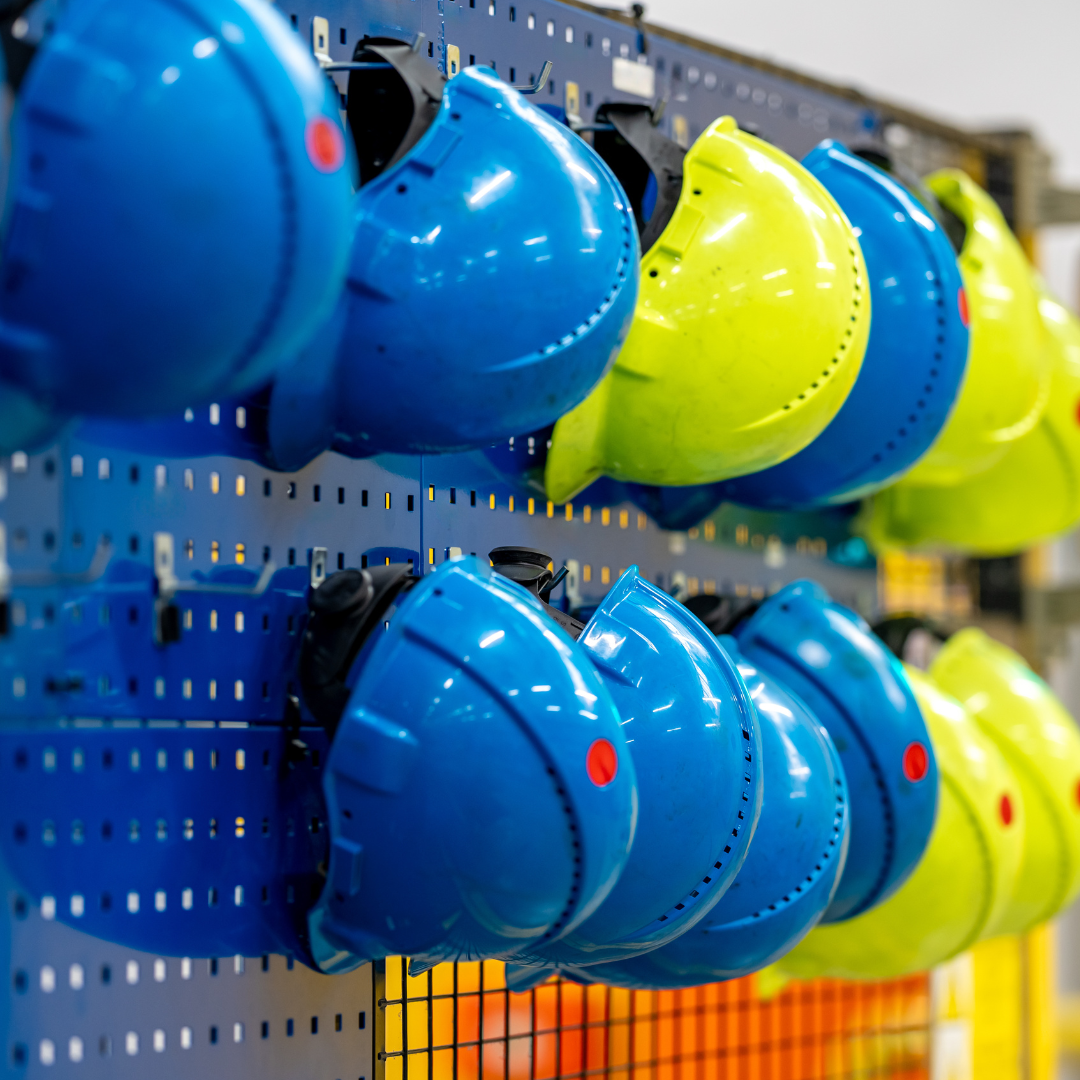 A selection of blue and yellow safety helmets.