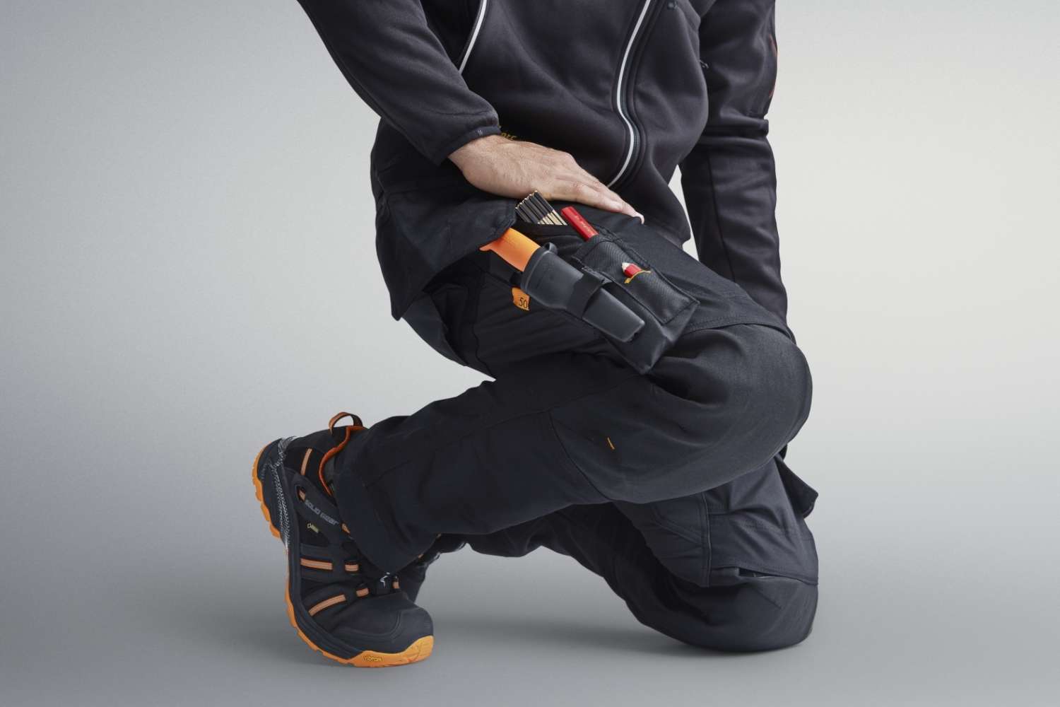 Man bending down in Snickers trousers