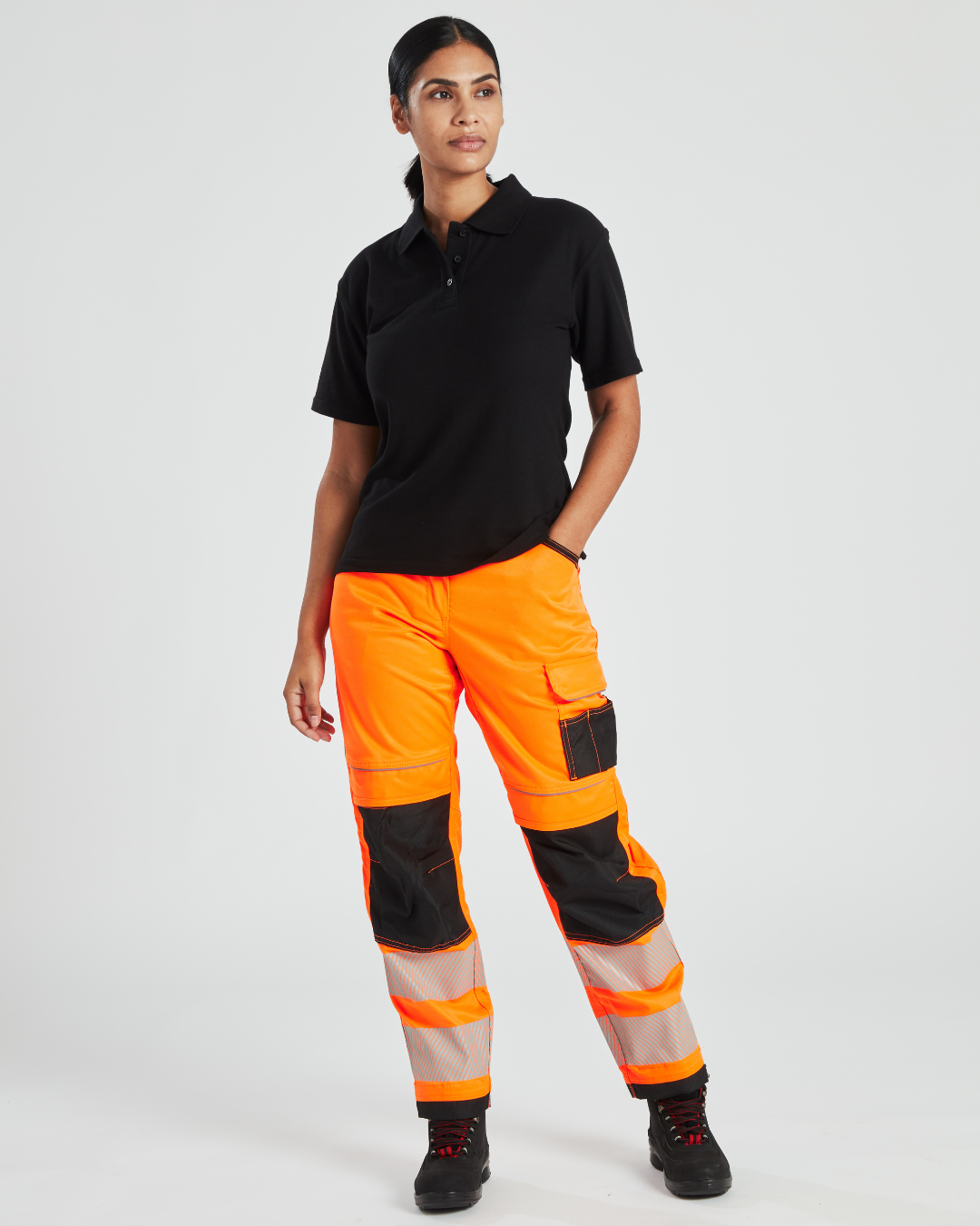 Woman wearing hi-vis orange work trousers.